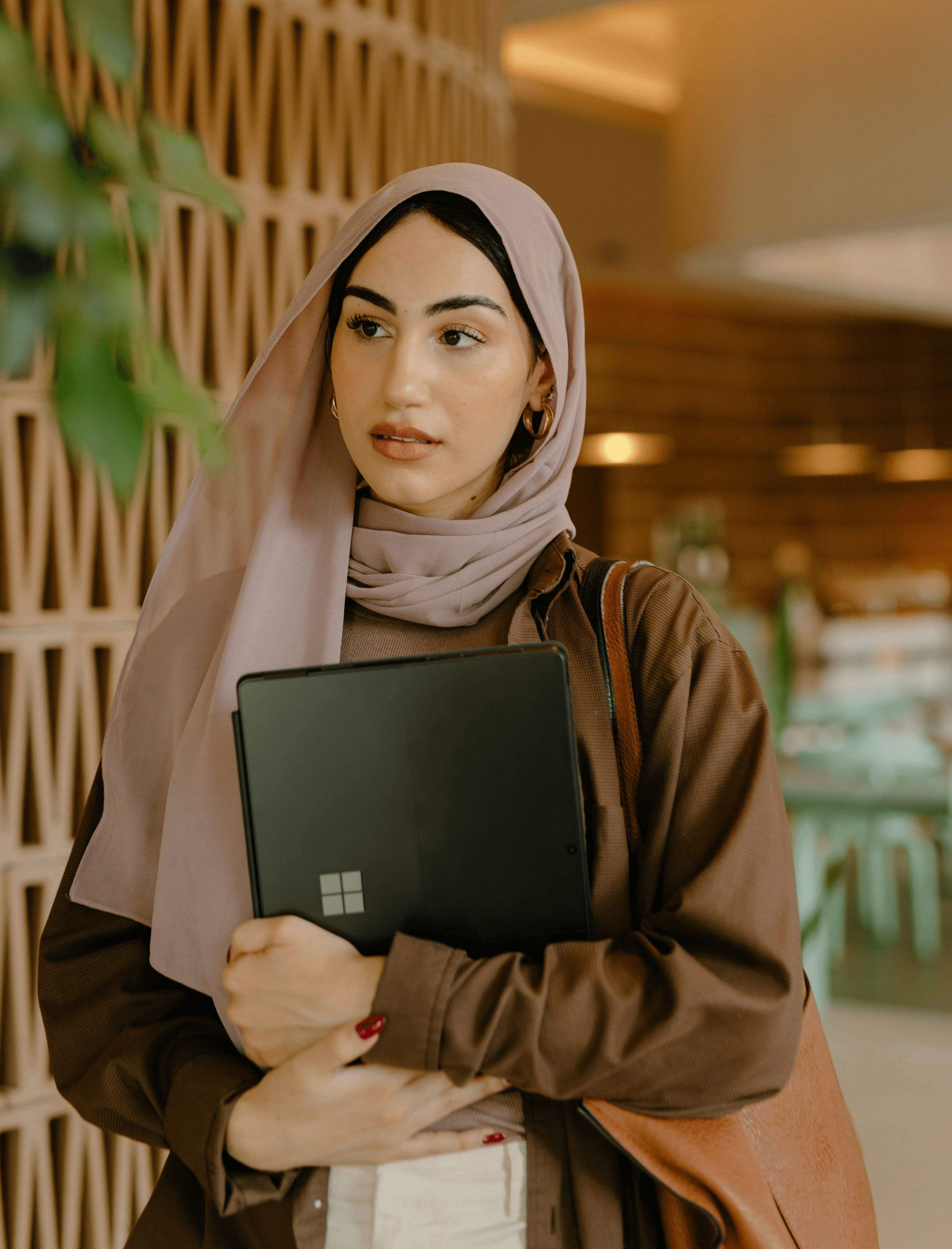 a person holding a laptop